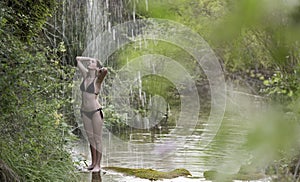 Teenage girl bathing in a lake. photo