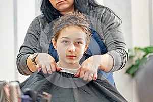 Teenage girl in a beauty salon on hair coloring and a haircut. Beauty concept. haircut, coloring