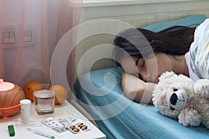 Teenage girl in bed at home caught cold, feeling bad, sleeping.