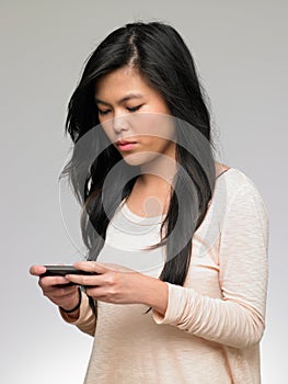 Teenage Girl Being Bullied By Text Message On Mobile Phone