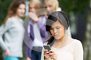 Teenage Girl Being Bullied By Text Message On Mobile Phone