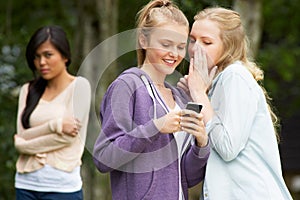 Teenage Girl Being Bullied By Text Message On Mobile Phone