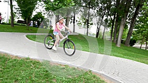 Teenage girl on a bicycle going down a hill