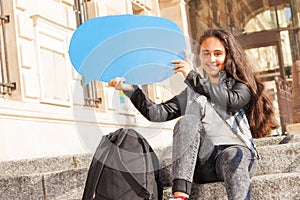 Teenage girl with blanked blue speech bubble