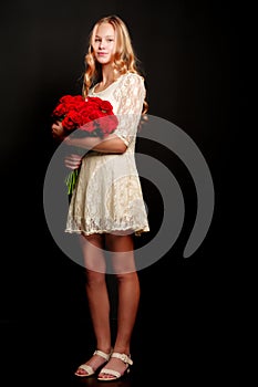 A teenage girl with a bouquet of flowers, on a black background.