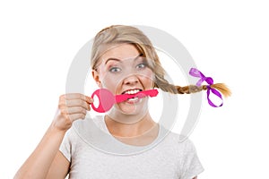 Teenage girl with braid biting key