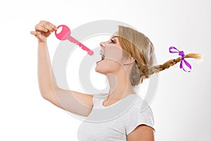 Teenage girl with braid biting key