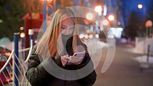 Teenage girl browsing internet on smart phone at night