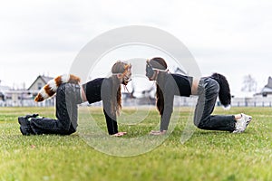 Teenage girl with cat mask and gloves doing Quadrobics. girl in a cat mask Jumps like a cat