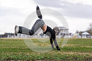 Teenage girl with cat mask and gloves doing Quadrobics. girl in a cat mask Jumps like a cat