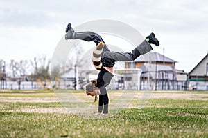 Teenage girl with cat mask and gloves doing Quadrobics. girl in a cat mask Jumps like a cat. the athlete is standing on