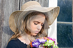 Teenage girl with colorful daisy bouquet