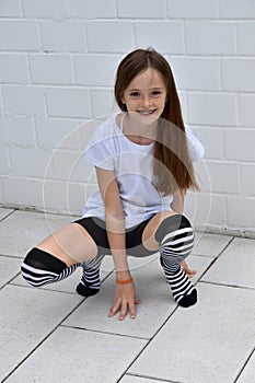 Teenage girl crouching photo