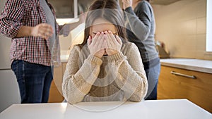 Teenage girl crying and getting upset because or family conflict. Family violence, conflicts and relationship problems