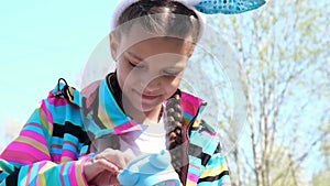 a teenage girl dances and has fun in anticipation of Easter, a child plays with an alarm clock