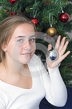 Teenage girl decorating New Year tree