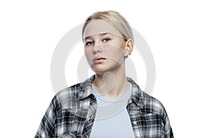 Teenage girl with a dissatisfied face. Cute blonde girl looking down. Depression and aggression. Isolated on a white background