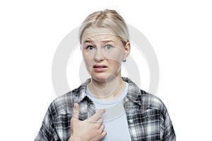 Teenage girl with a dissatisfied face. Cute blonde girl looking down. Depression and aggression. Isolated on a white background