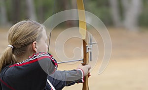 Teenage girl doing archery photo