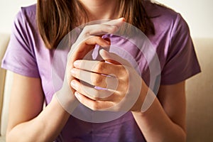 Teenage girl doing EFT - tapping on the side of the hand