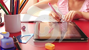Teenage girl doing homework on tablet computer