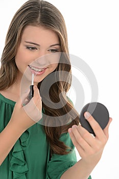 Teenage girl doing make-up. Cheerful teenage girl doing make-up