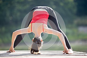 Teenage girl doing Standing Straddle Forward Bend