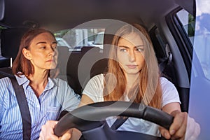 Teenage girl during driving lesson in a car