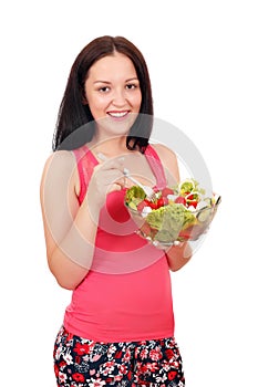 Teenage girl eating salad