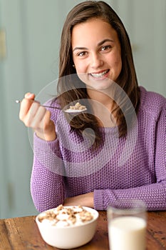 Teenage girl enjoy healthy cereal breakfast smile