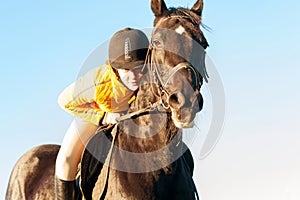 Teenage girl equestrian riding horseback ready to jump. Vibrant