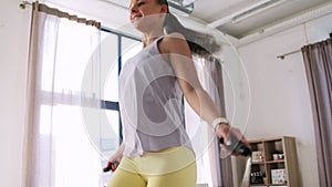 teenage girl exercising with jump rope at home