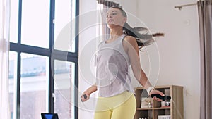 teenage girl exercising with jump rope at home