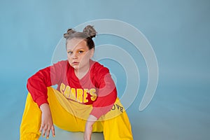 teenage girl in fashion stylish bright clothes. little lady in red and yellow on blue background. makeup and hairdo