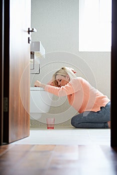 Teenage Girl Feeling Unwell In Bathroom photo