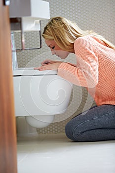 Teenage Girl Feeling Unwell In Bathroom photo