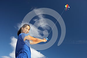 Teenage girl flying a kite