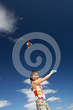 Teenage girl flying a kite