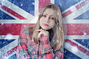 Teenage girl on frozen background with flag of Great Britan. Concept of crisis in Europe in winter. Energy crisis