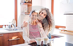 A teenage girl with grandmother at home. photo