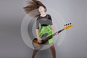 Teenage girl with guitar, shaked head photo