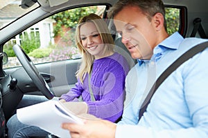 Teenage Girl Having Driving Lesson With Instructor photo