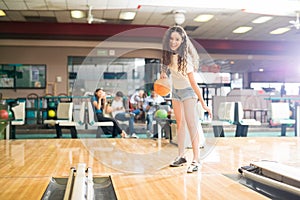 Teenage girl having fun in a bowling alley