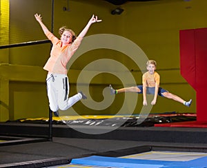 Teenage girl having fun jumping in indoor trampoline arena