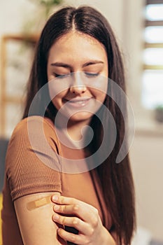 Teenage girl having plaster on arm .Virus protection. Covid-19 vaccination. HPV vaccine