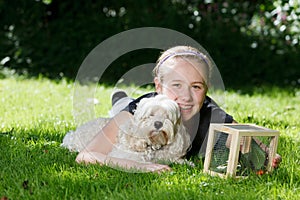 Teenage girl with her dog outside .