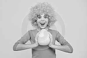 Teenage girl hold citrus fruit pummelo or pomelo, isolated on yellow background. Summer fruits. Excited teenager, glad