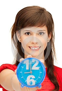 Teenage girl holding alarm clock