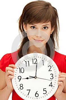 Teenage girl holding big clock