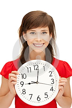 Teenage girl holding big clock